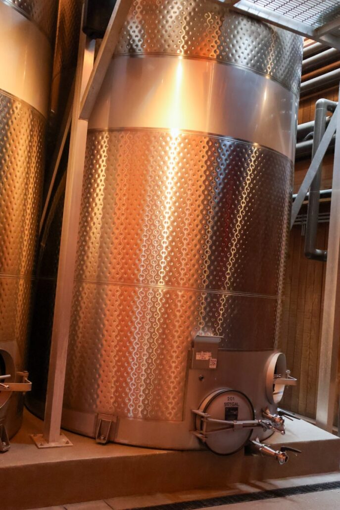 winery equipment a large metal tank sitting inside of a building